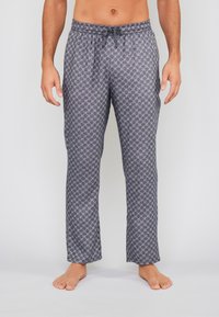 Mannen pyjamabroek in donkergrijs met een geometrisch patroon. Voorzien van een tailleband met trekkoord en taps toelopende benen. Zachte stofstructuur.