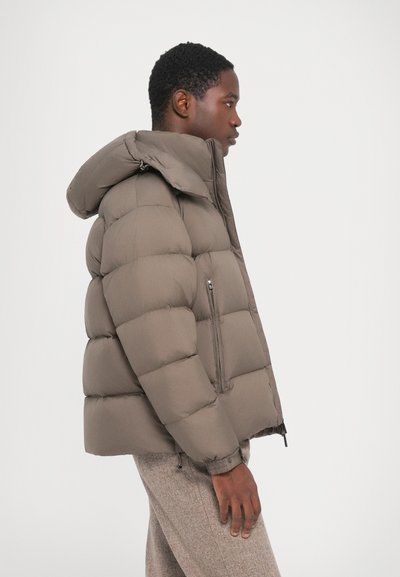 Brown puffer jacket with a hood and a zippered side pocket. The fabric appears smooth and is quilted with large sections for insulation.