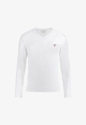 Valkoinen pitkähihainen V-kauluspaita, joka on valmistettu puuvillasta, ja jossa on punainen kolmiomainen logo vasemmassa rinnassa. Paita on sileä ja se on muotoilultaan istuva.