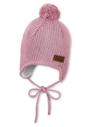 Knitted pink hat with a pom-pom on top, ear flaps, and ties. Lined with soft fabric, features a small brown logo patch on the side.