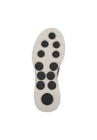 Shoe sole featuring a white base with textured black circular traction pads arranged in a specific pattern for grip and support.