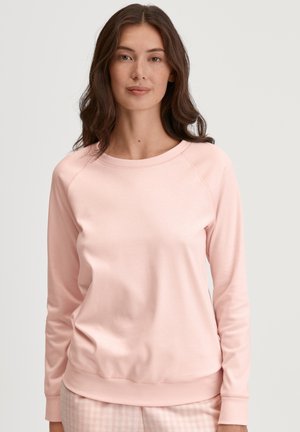 Lichtroze sweatshirt met een ronde halslijn, raglanmouwen en geribbelde rand. Zachte stof, casual pasvorm. Eenvoudig ontwerp, geen zichtbare hardware.
