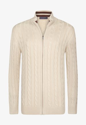 Cream-colored cable-knit cardigan with a full zipper, high collar, ribbed cuffs, and hem. Features subtle brown striped accents inside the collar.