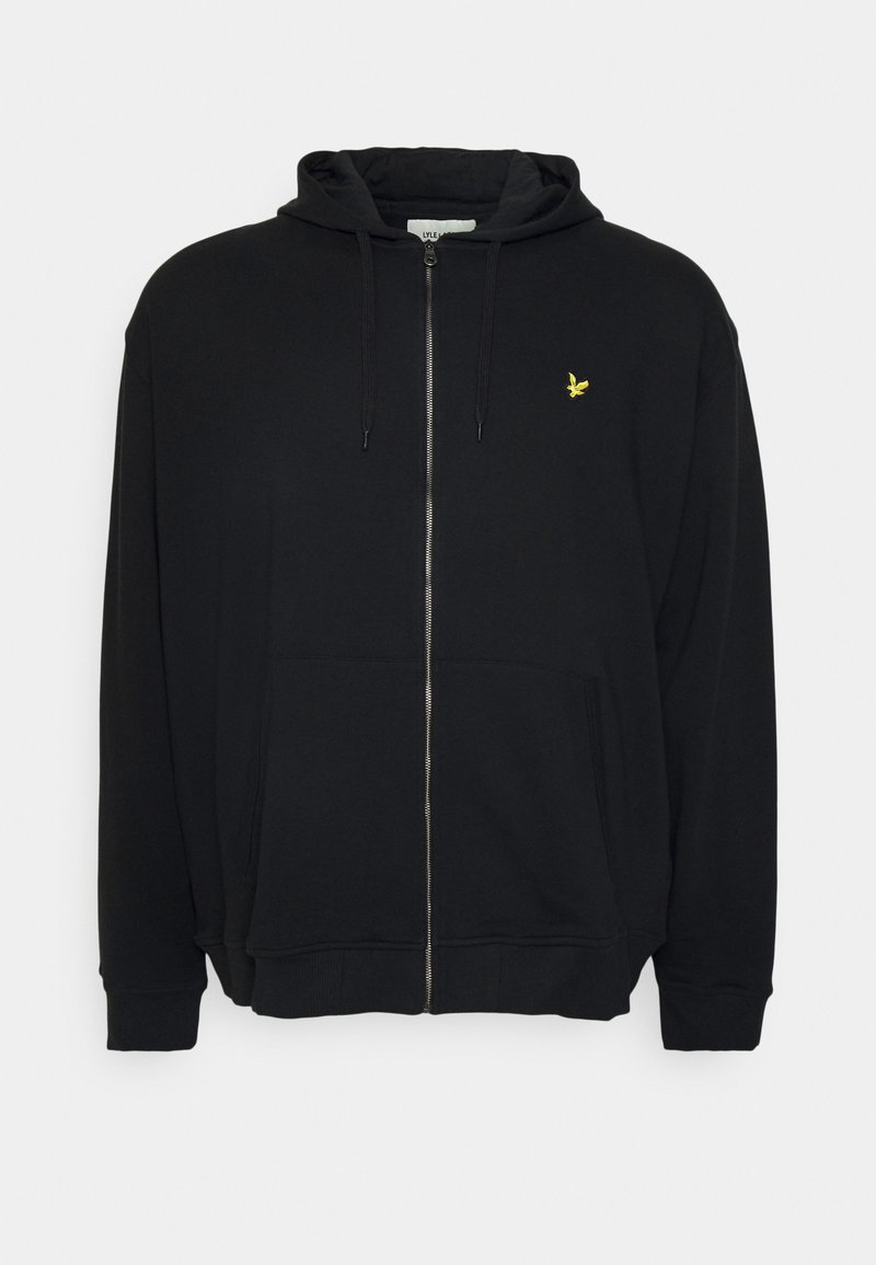 Hoodie noir zippé en mélange de coton. Il présente une poche avant, une capuche avec cordon de serrage, et un petit logo jaune sur la poitrine.