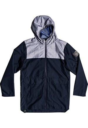 Veste à capuche avec fermeture éclair à l'avant, corps bleu marine foncé, partie supérieure gris clair, deux poches avant et un écusson sur la manche gauche.