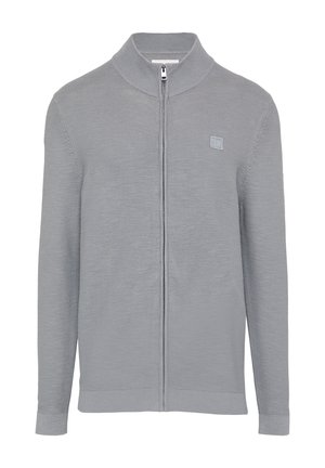 Halli halli kasukaga, millel on kõrge krae, pehme tekstuur ja väike logo plaastriga vasakul rinnal.