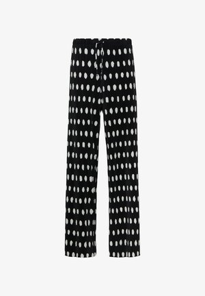 Zwarte broek met witte ovale stippen, geplooide textuur, elastische tailleband en een trekkoord voor een verstelbare pasvorm. Wijde pijpen.