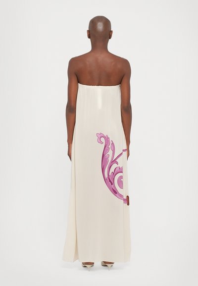 Strapless beige maxi dress with soft fabric, featuring a pink floral design on one side and a straight silhouette down to the floor.
