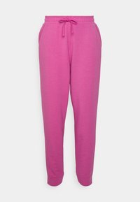 Jasnoróżowe dresowe spodnie z elastycznym pasem, sznurkiem, bocznymi kieszeniami i manszetami na nogawkach, przedstawione na jednolitym białym tle.