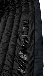 Black insulated jacket featuring quilted pattern, smooth texture, and a glossy logo on the side. Edges finished in a contrasting dark material.