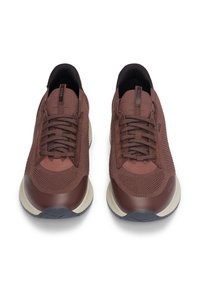 Chaussures de sport marron avec une tige en tricot texturé, un design à bout rond, un laçage à l'avant et des semelles contrastantes écru.