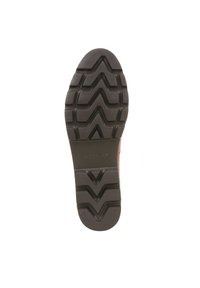 Suola di scarpa nera in gomma con un motivo di battistrada a zigzag testurizzato, logo Vionic in rilievo vicino al tallone e un bordo solido e piatto.