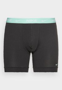 Sorte bomulds boxer briefs med en mintgrøn Nike-logo i taljen. Har en tætsiddende pasform og blød tekstur. Ingen synlige mønstre eller detaljer.
