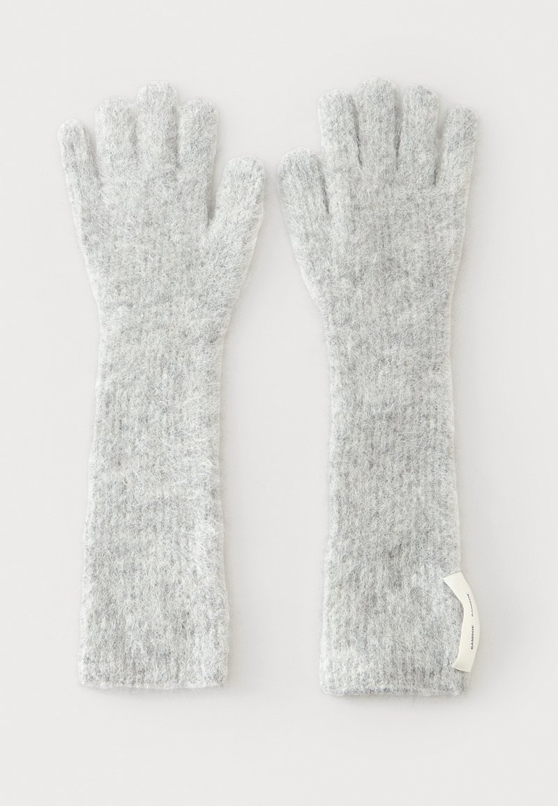 Gants longs gris clair duveteux avec cinq doigts et poignets allongés, posés à plat côte à côte sur un fond blanc.