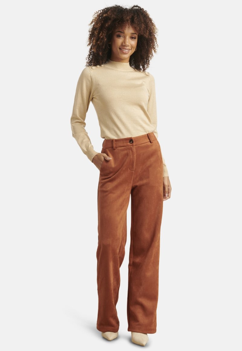 Beige fitted top and rust-colored, wide-leg corduroy pants with a smooth texture. Pants feature a front button closure and side pockets.