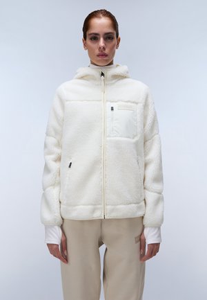 White fleece jacket with a hood, textured surface, front zipper, and a small chest pocket. Paired with light beige trousers.