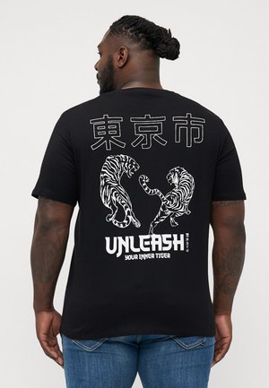Black cotton t-shirt featuring white tiger graphics, Japanese text, and the phrase "UNLEASH YOUR INNER TIGER" on the back.