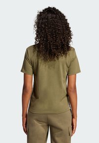 Olive green cotton t-shirt with short sleeves, round neckline, and a relaxed fit. Smooth texture, minimal stitching details.