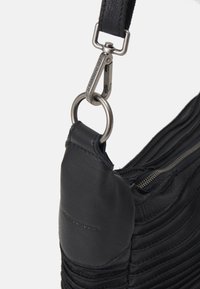 Schwarze Leder-Schultertasche mit strukturiertem, plissiertem Design. Verfügt über einen silbernen Metallschnapper und einen Reißverschluss, akzentuiert durch ein glattes Panel an der Oberseite.