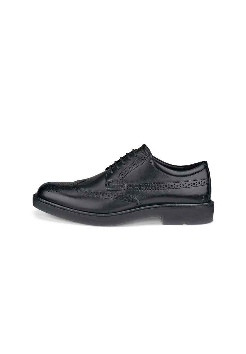Schwarze Leder-Dressschuhe mit Wingtipschnitt und durchbrochener Detailgestaltung. Rund zulaufende Fußspitze, Schnürverschluss und flache Gummisohle.