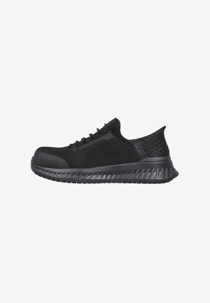 Black athletic shoes with a textured mesh upper and a solid rubber sole. Features a rounded toe and lace-up design for secure fit.