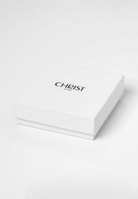 Weißer Karton mit glatter Oberfl�äche, auf dessen Deckel in fetter schwarzer Schrift der Markenname "CHRIST" zentral platziert ist.