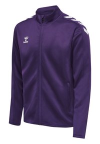 Veste violette avec un col montant et une fermeture éclair. Dotée d'accents en chevron blanc sur les épaules et les poches latérales. Fabriquée en tissu lisse.
