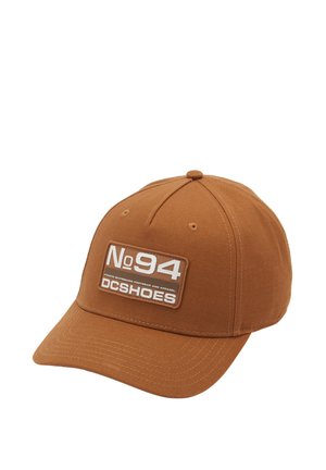 Brown cap made of cotton, featuring a front patch displaying "No94 DCSHOES" in white and grey on a rectangular background.