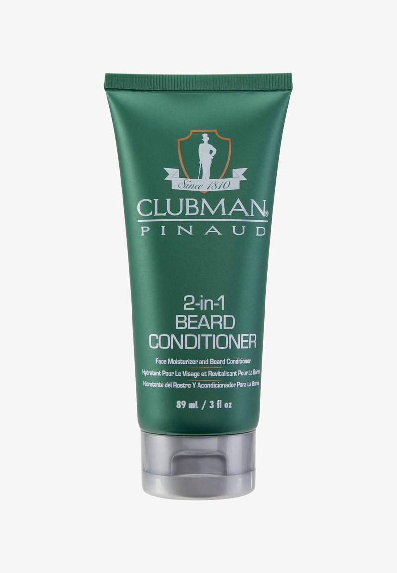 Tube en plastique vert étiqueté "Clubman Pinaud 2-en-1 après-rasage pour barbe" avec un capuchon gris, 89 mL. Texte en blanc, avec un emblème.