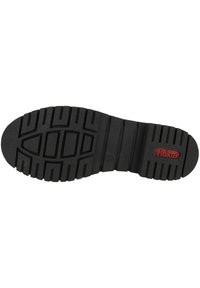Black rubber shoe sole featuring an embossed tread pattern for traction, with a red brand logo accent near the heel.