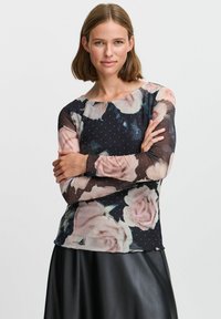 Bluza z dolgimi rokavi iz prozorne tkanine, okrašena s črnim cvetličnim vzorcem, svetlo rožnatimi vrtnicami in belimi pikami. Mehka tkanina z zaobljenim ovratnikom.