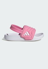 Růžová nazouvací sandála s polstrovaným páskem, bílou podrážkou, texturovaným svrškem a vystouplým logem. Lehký design vhodný pro běžné nošení.