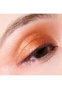 Close-up of an eye featuring an orange shimmery eyeshadow with a smooth texture, brown iris, and defined eyelashes, highlighting eyelid contours.