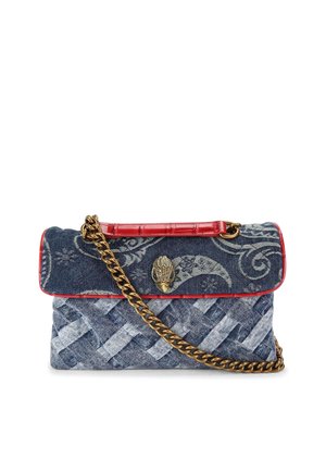 Denim bag with blue and white woven pattern, red leather trim, gold chain strap, and a decorative metallic clasp featuring an intricate design.