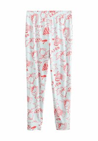 Fehér leggings piros illusztrációkkal bögre teákról, tortákról, gombákról, csillagokról, almákról, valamint a "KÉNYELMES" és a "SZEZON" szavakról, amelyek mindenhol nyomtatva vannak.