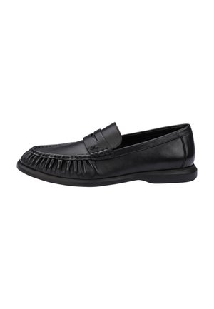 Sort læderloafer med synet moc-toe-design og lav hæl, vist fra siden på en hvid baggrund.