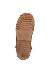 Semelle en caoutchouc marron avec un motif en zigzag texturé et un label rectangulaire "Warmbat Australia". Présente des bords arrondis et des découpes sur les côtés.