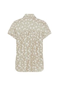 Blusa a maniche corte in tessuto beige chiaro con motivo floreale bianco e dettaglio plissettato sul retro. Presenta un colletto a punta e un orlo curvo.