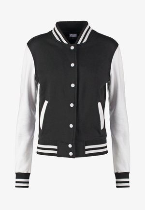 Black and white varsity jacket with a ribbed collar, front snap buttons, and striped cuffs. Material is a blend of fabric and synthetic.