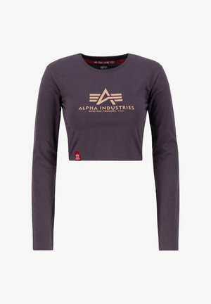 Krátky top v tmavosivej bavlne s dlhými rukávmi, s kultovým zlatým logom na hrudi a malou červenou nášivkou na leme.