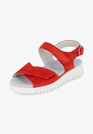 Sandale rouge vif à bout ouvert avec semelle épaisse blanche à relief, bride de cheville réglable et large bride velcro à l’avant, présentée sur fond blanc.