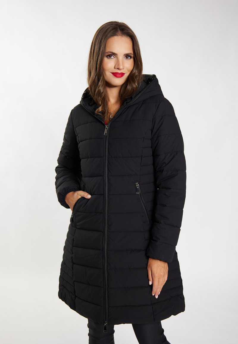 Cappotto imbottito nero con cappuccio, caratterizzato da pannelli trapuntati, due tasche laterali con zip e una zip Frontale completa. Tessuto liscio e strutturato.