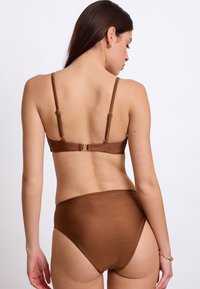 Set di bikini marrone con un design semplice, dotato di spalline regolabili e chiusura con gancetto, realizzato in tessuto liscio e lucido. Slip a vita alta.