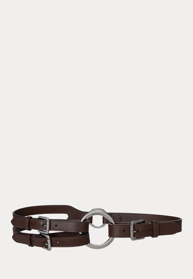 Brown leather belt with two adjustable straps, featuring a circular metallic buckle and sleek stitching details. Smooth texture overall.