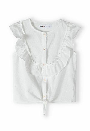 Biała bluzka z krótkim rękawem z falbaną przy dekolcie i zapięciem na guziki. Charakteryzuje się teksturowaną tkaniną z małymi wypukłymi kropeczkami oraz detalem w postaci wiązania na dole.