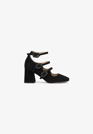 Chaussures à talons hauts en suede noir avec un bout carré, dotées de trois brides de cheville ornées de ferrures décoratives noires. Design à talon épais.