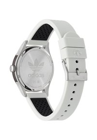 Balta silikoninė apyrankės laikrodžio su nerūdijančio plieno korpusu. Savybės perforuoti akcentai ir išgraviruotas logotipas ant korpuso nugarėlės.