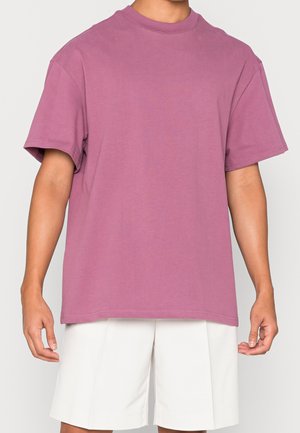 Short-sleeve crew neck t-shirt in soft, lightweight purple cotton, featuring a relaxed fit and solid color with no graphics or patterns.