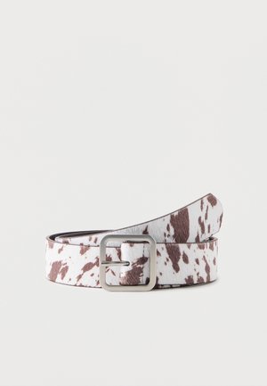 White and brown cow print belt with a silver rectangular buckle, coiled on a plain light background.