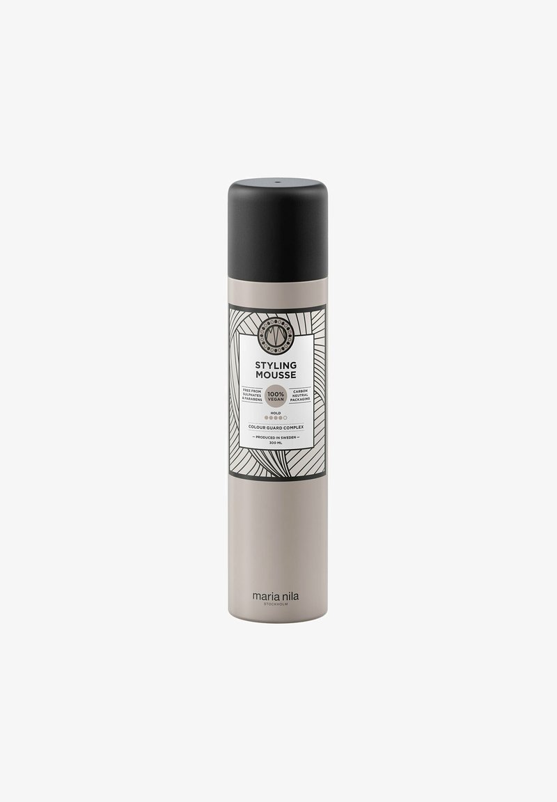 300 ml cylindrical styling mousse bottle in matte beige with a black cap and white label featuring a leaf pattern and product information.